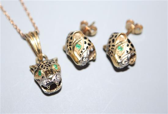 A modern 14ct, ruby and diamond set leopards head pendant on a 9ct chain and a pair of 14ct, emerald and diamond ear studs.